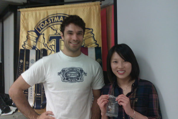 Lily holds up her new Toastmasters International pin.