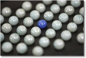 purple ball among white balls